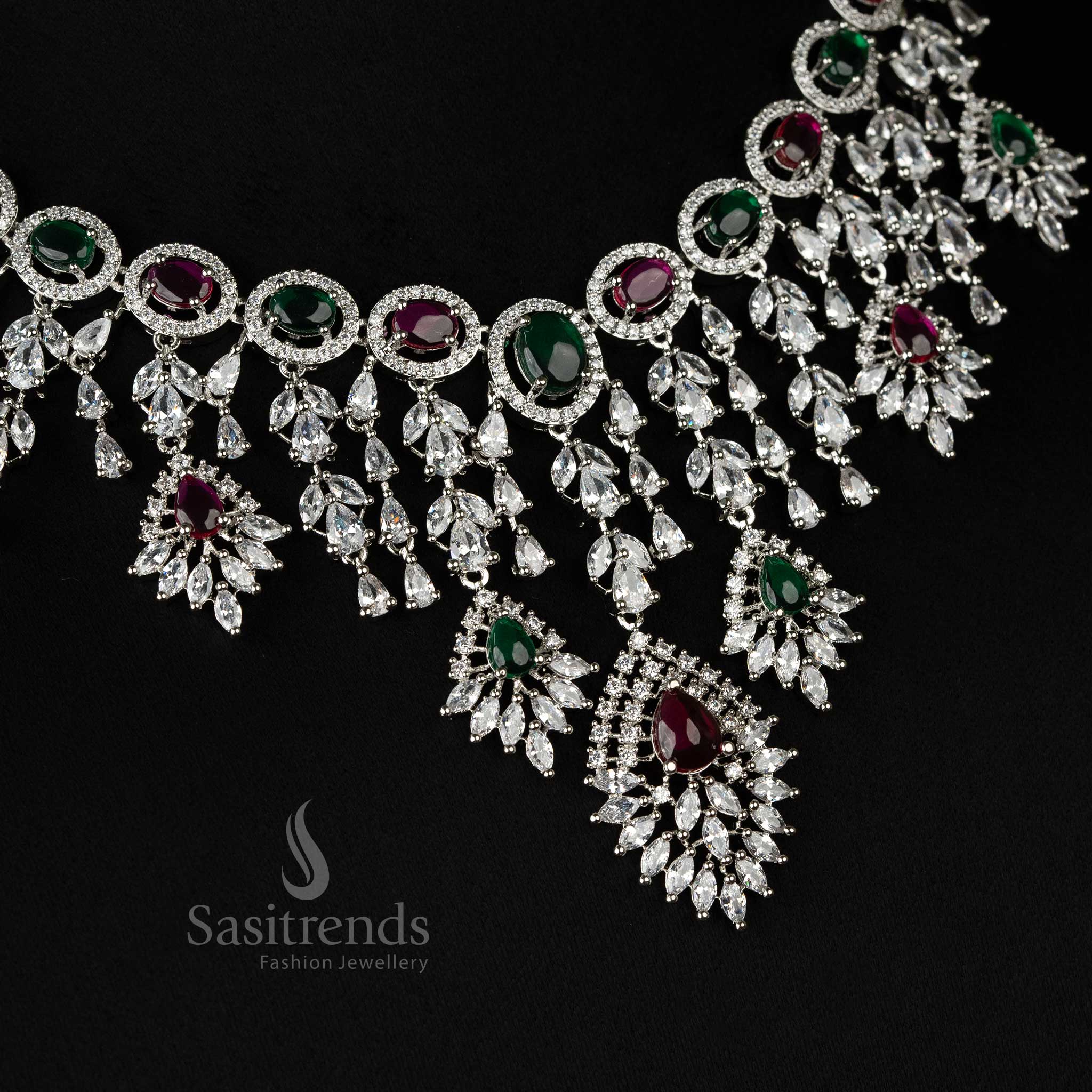 Exquisite rhodium-plated necklace jewellery set with American diamonds, blending ruby and green tones for a glamorous wedding look - Sasitrends