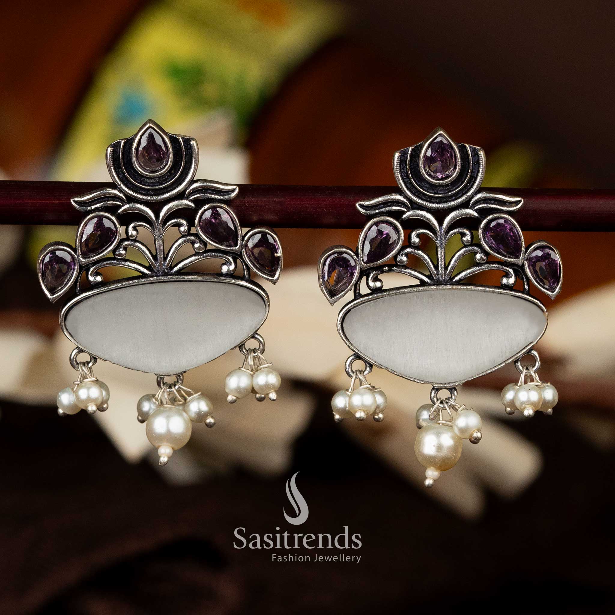 Oxidised silver earrings with white and Purple teardrop stone and lotus accents - Sasitrends