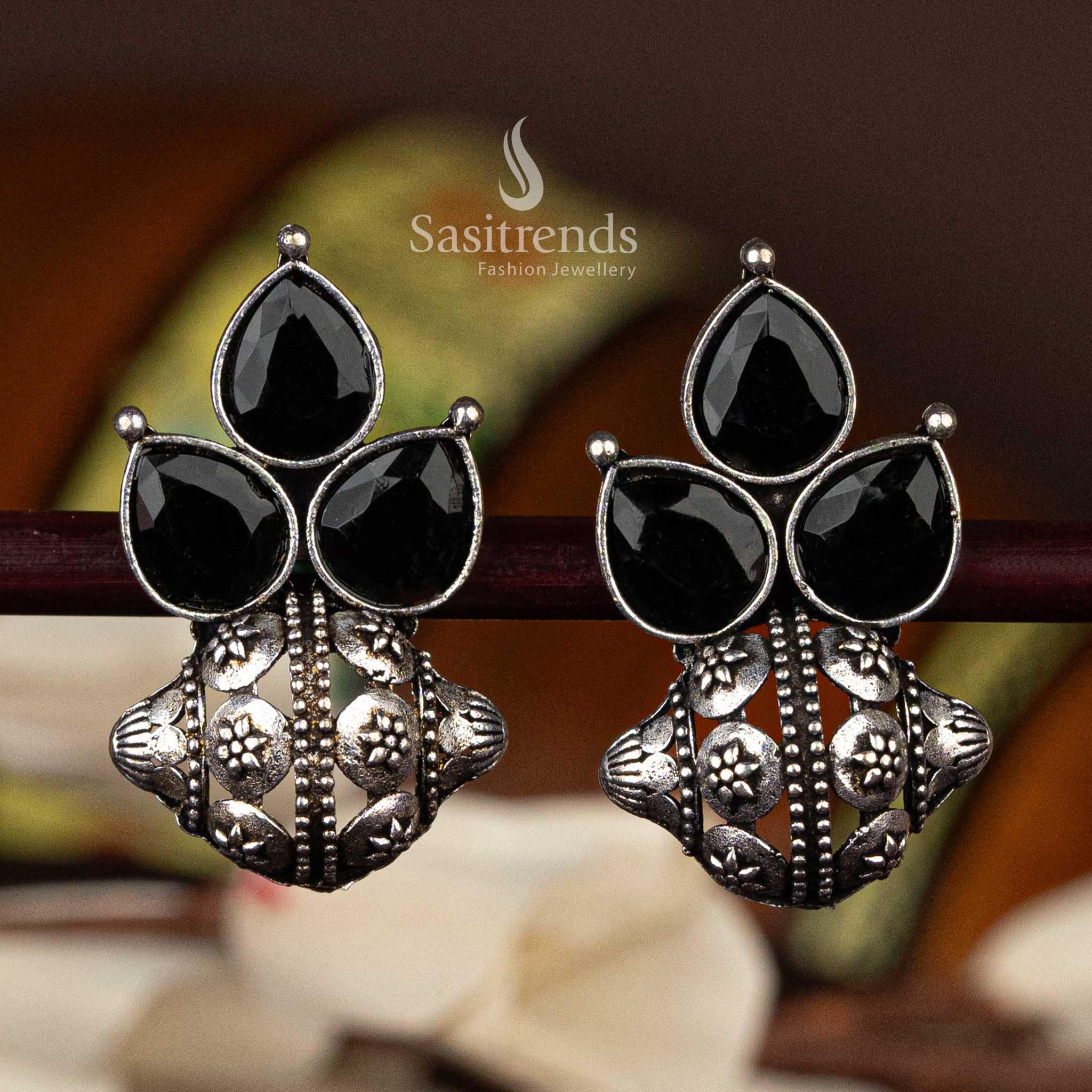 Black pear-shaped stone oxidised silver earrings with floral details  - Sasitrends