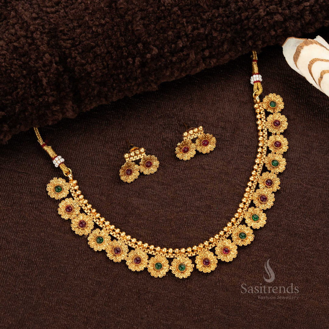 Floral design matte gold-plated temple necklace set adorned with ruby and green synthetic stones, paired with matching earrings - Sasitrends