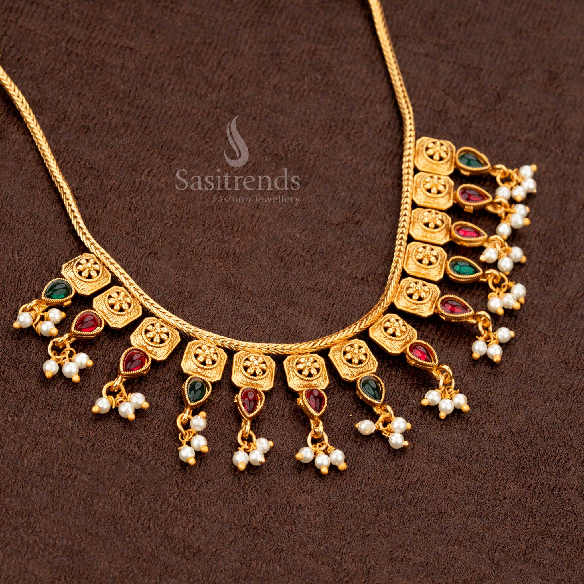 Matte gold temple jewellery featuring square floral motifs with ruby-green accents - Sasitrends