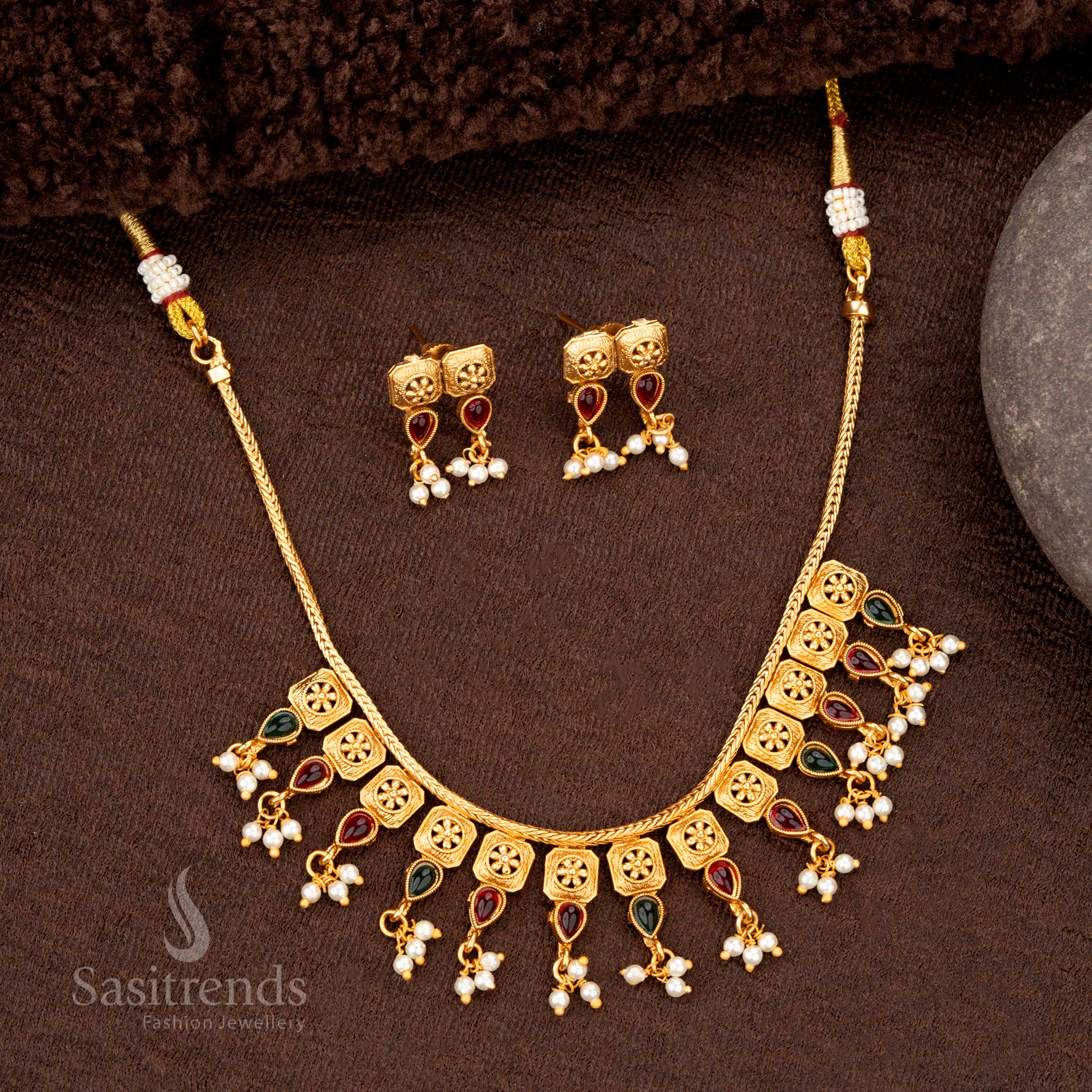 Matte gold temple jewellery featuring square floral motifs with ruby-green accents - Sasitrends