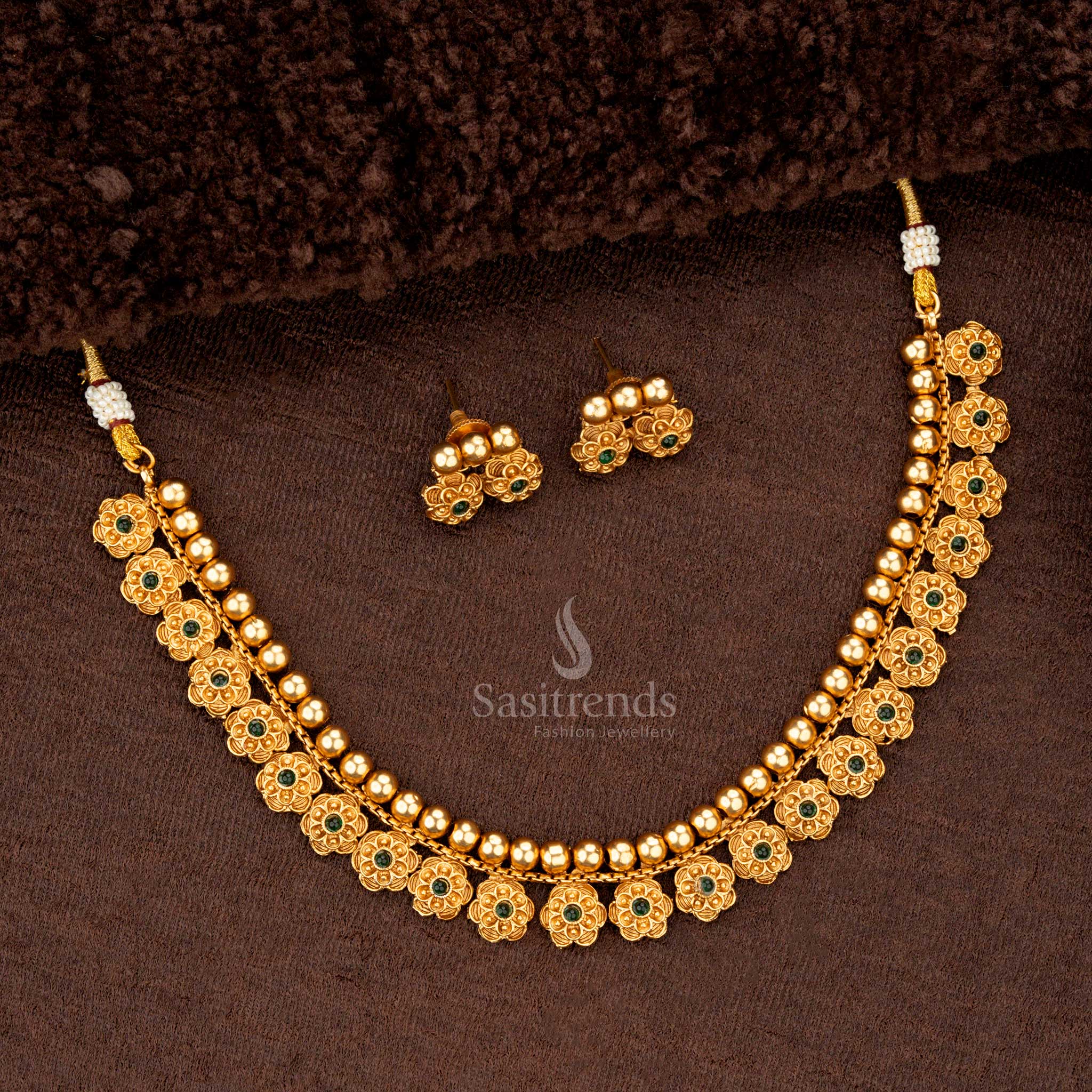 Matte gold-plated necklace with green stone flower motifs for saree wear - Sasitrends