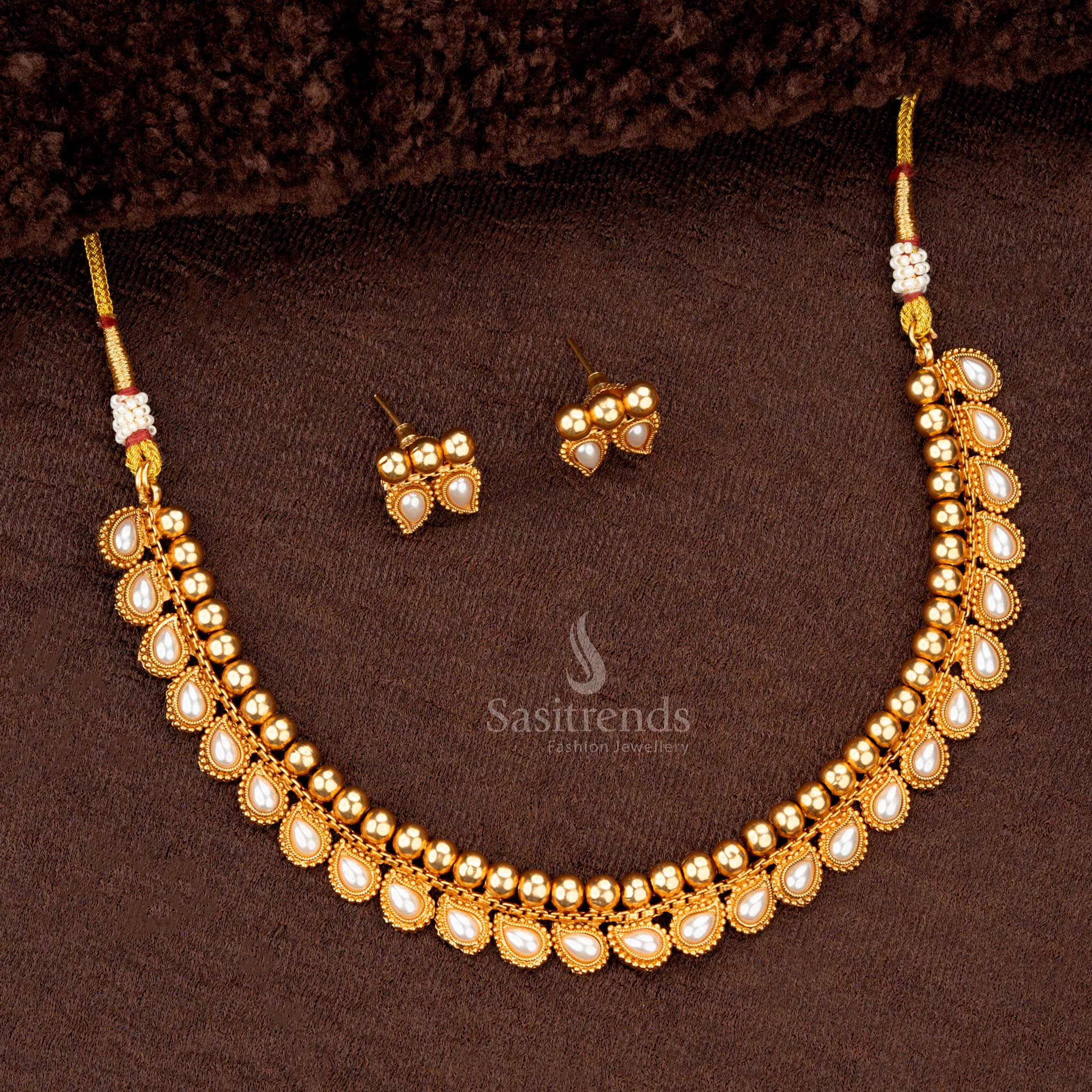 Traditional necklace featuring teardrop motifs, pearls, and gold-tone beads - Sasitrends