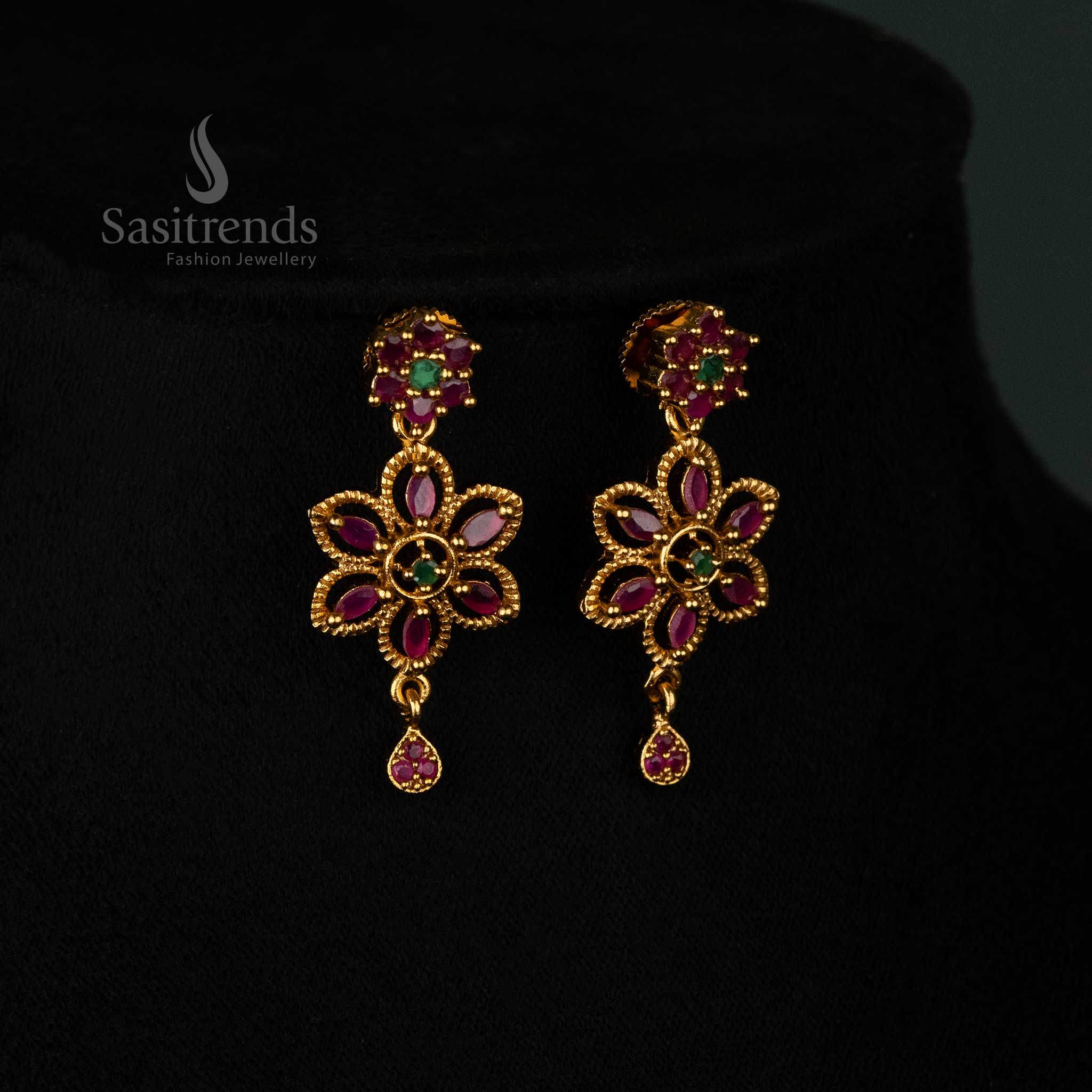 Graceful floral swirl design matte gold plated earrings set adorned with radiant ruby-green AD stones, stylish drop pendant, and charming earrings - Sasitrends