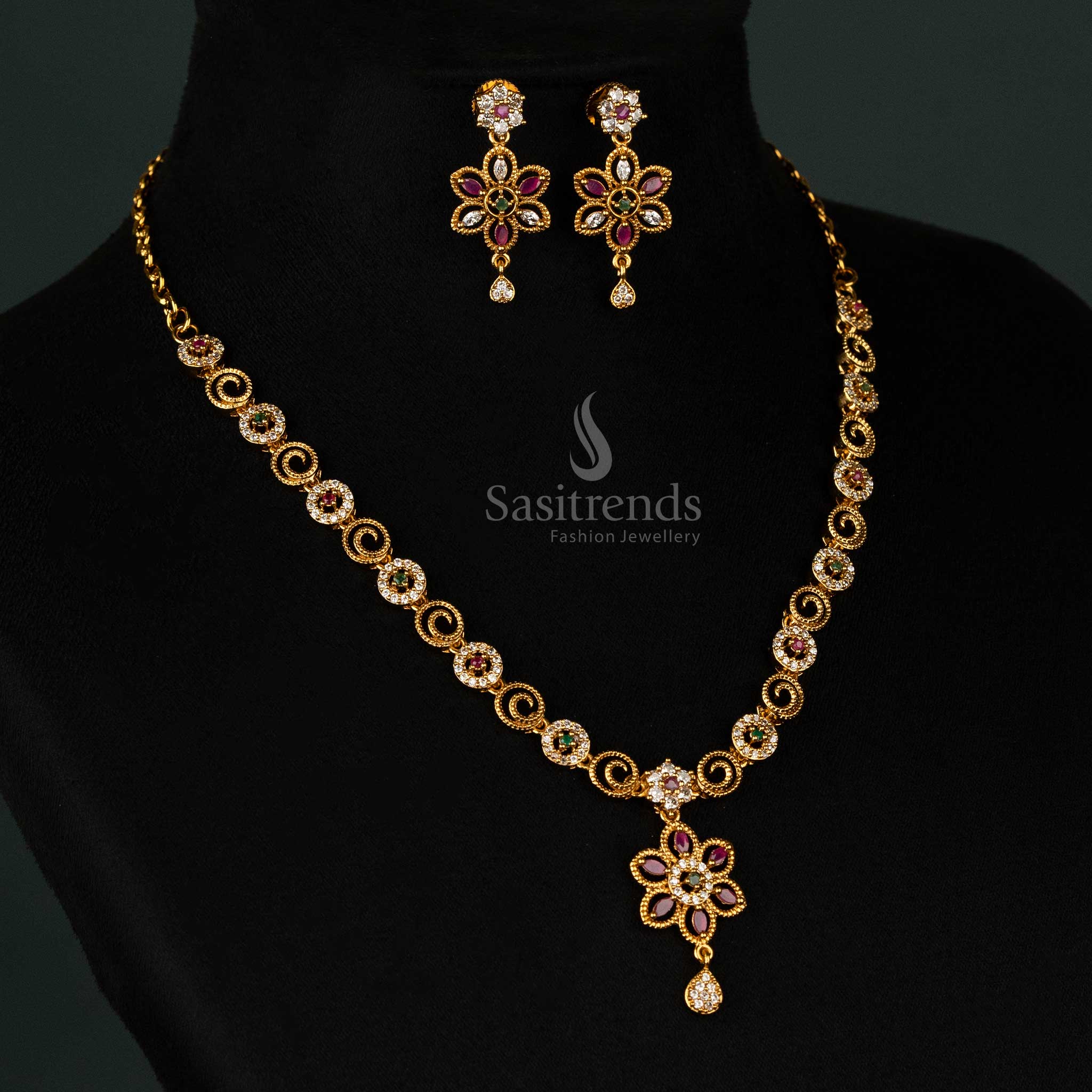 Intricately designed floral swirl matte gold plated necklace set decorated with dazzling multi-color stones, a sophisticated drop pendant, and luxurious earrings - Sasitrends