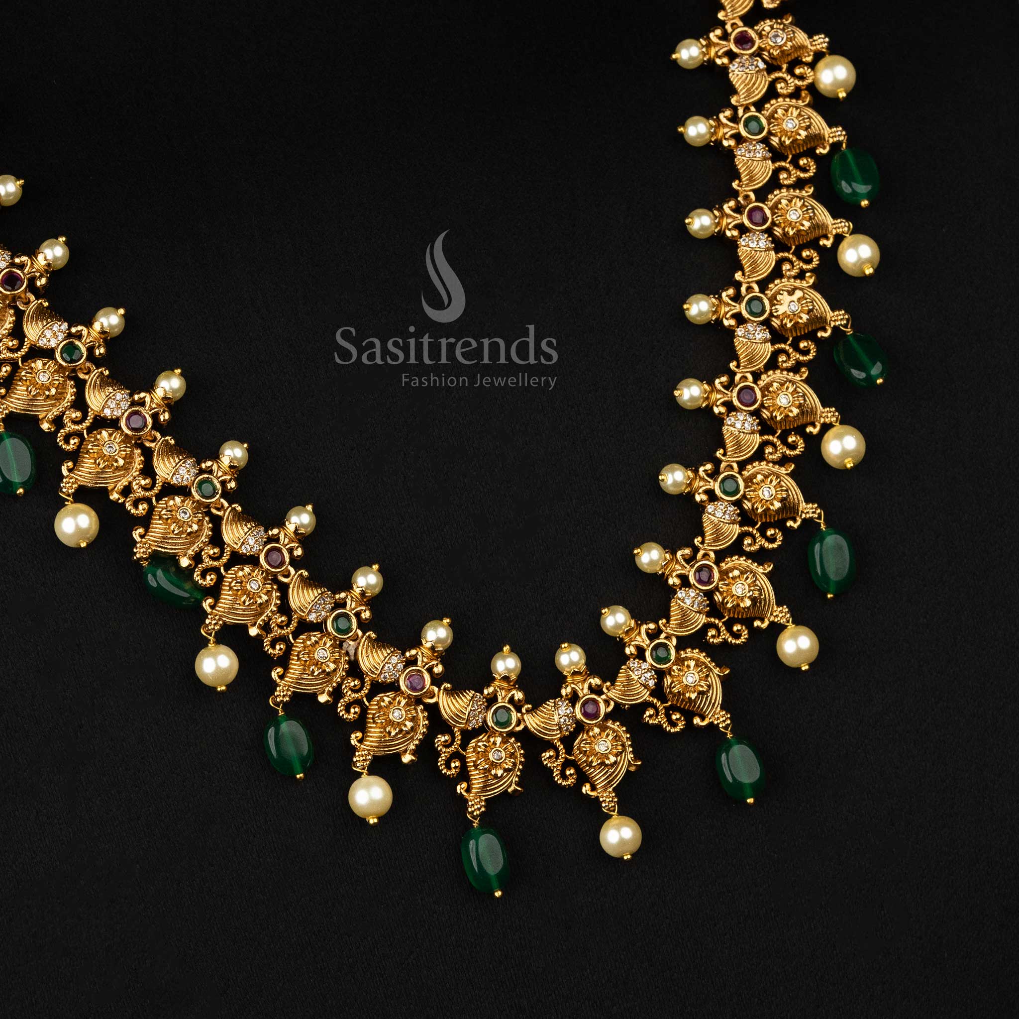 Ornate matte gold temple jewellery adorned with mango and flower motifs, accented by green beads and pearls - Sasitrends