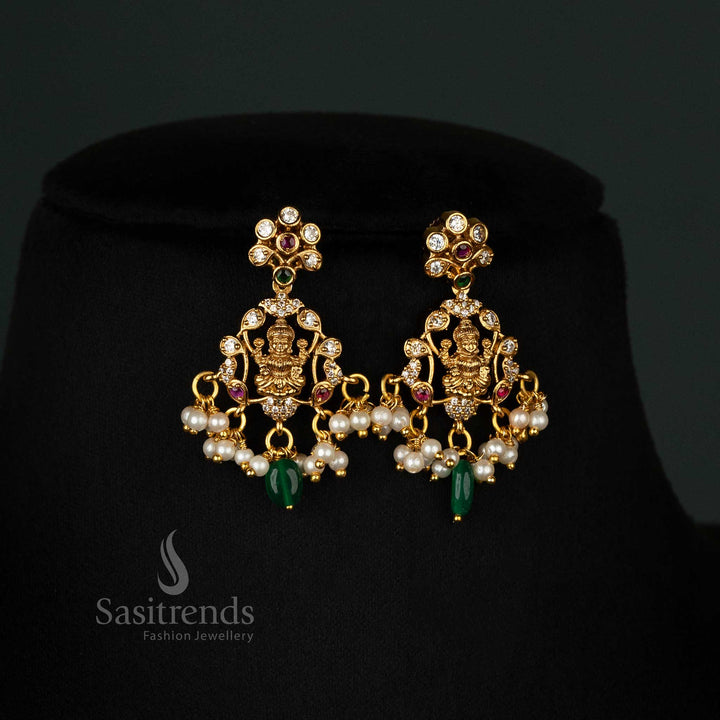 Graceful temple matte gold-plated necklace set featuring a Lakshmi pendant, intricate peacock motifs, and elegant pearls - Sasitrends