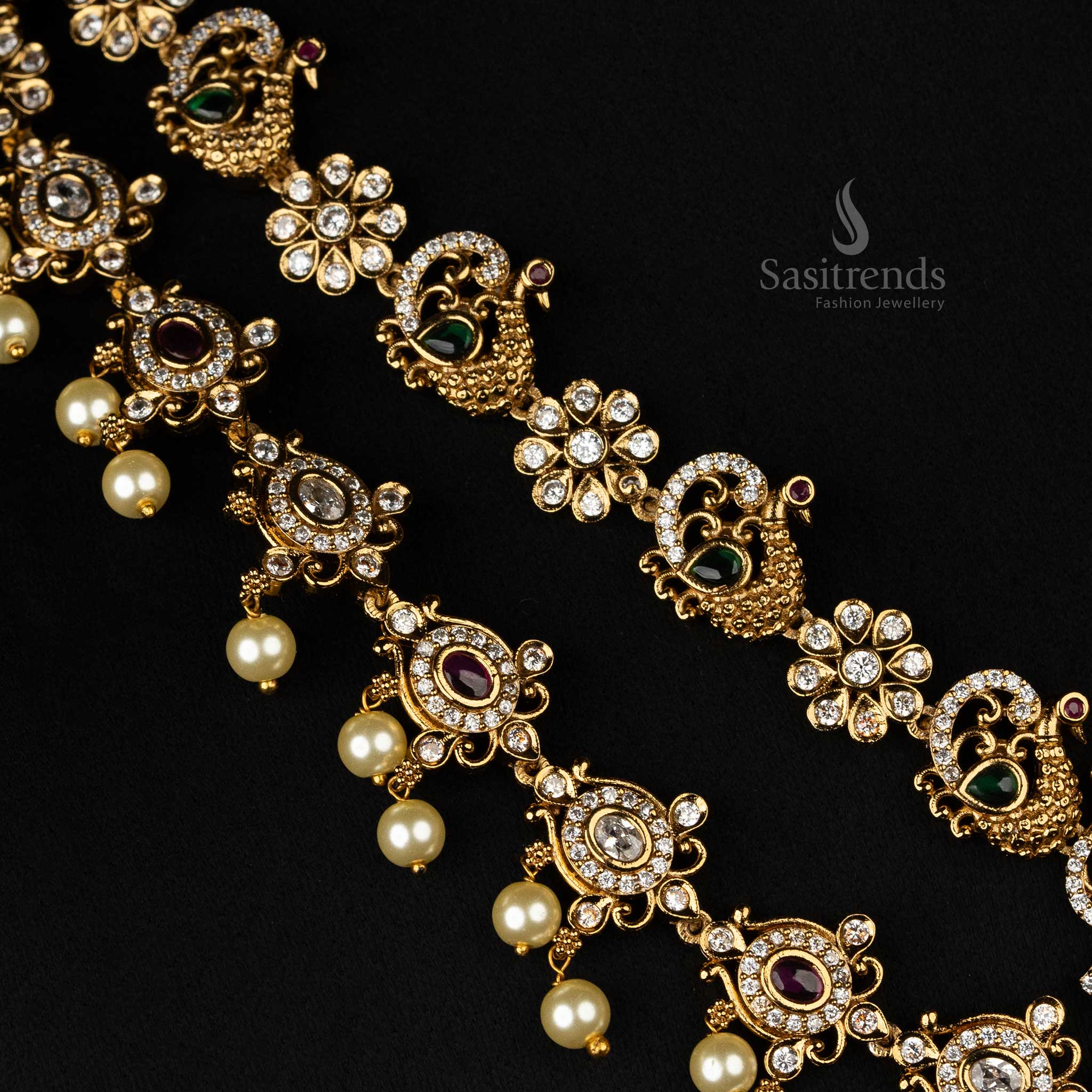 Ornate two-line temple jewellery set with matte gold finish, intricate Lakshmi motifs, peacock accents, and hanging pearls - Sasitrends