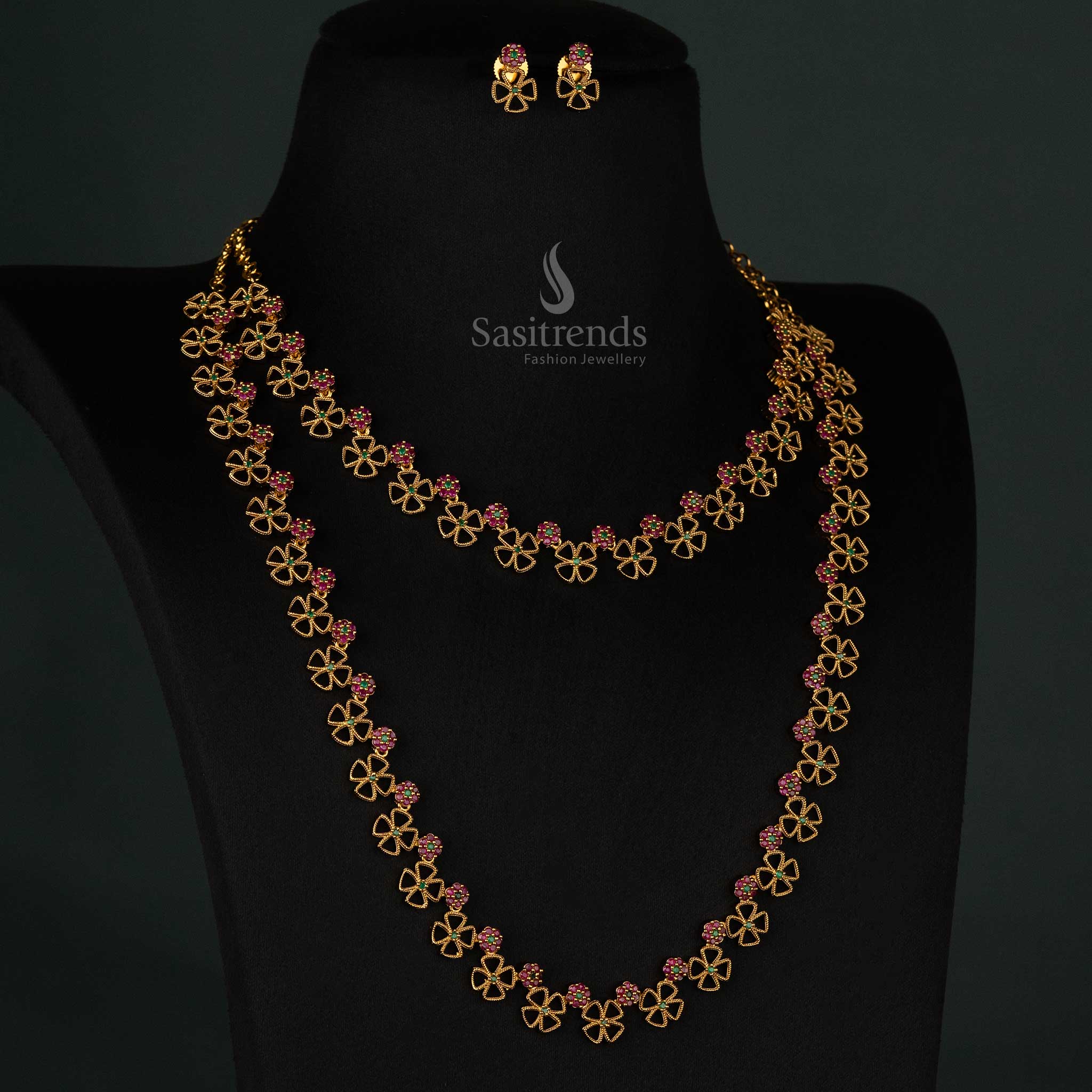 Magnificent floral clover matte gold plated long and short necklace set featuring dazzling ruby-green AD stone detailing and matching earrings - Sasitrends