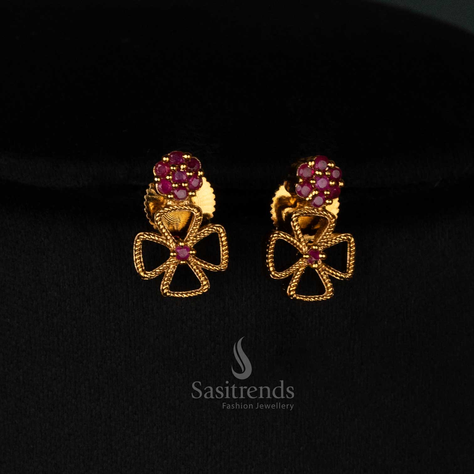 Intricately crafted floral clover matte gold plated necklace set adorned with dazzling ruby AD stones and matching earrings - Sasitrends