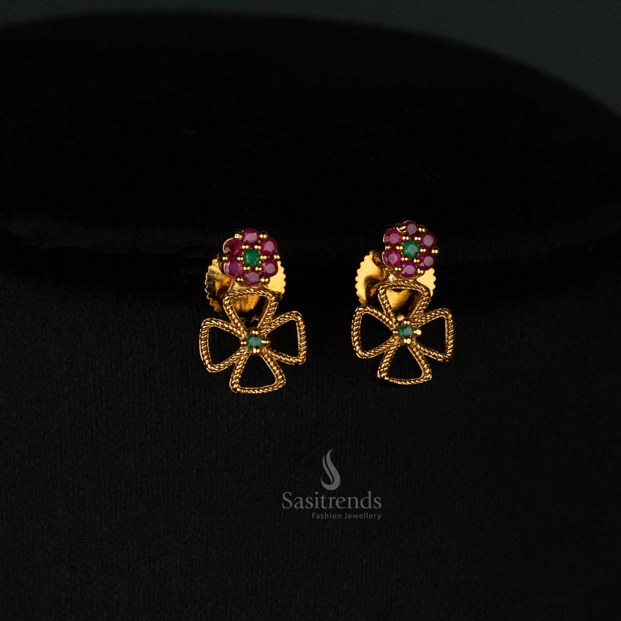 Graceful matte gold plated long and short floral clover earrings set with glowing ruby-green AD stones and designer jewellery - Sasitrends