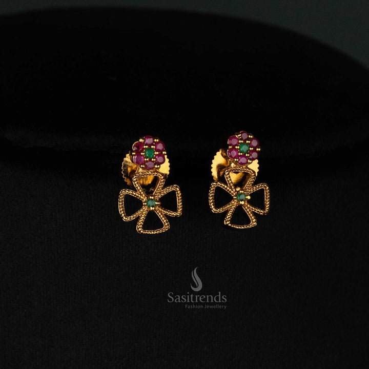 Graceful matte gold plated long and short floral clover earrings set with glowing ruby-green AD stones and designer jewellery - Sasitrends