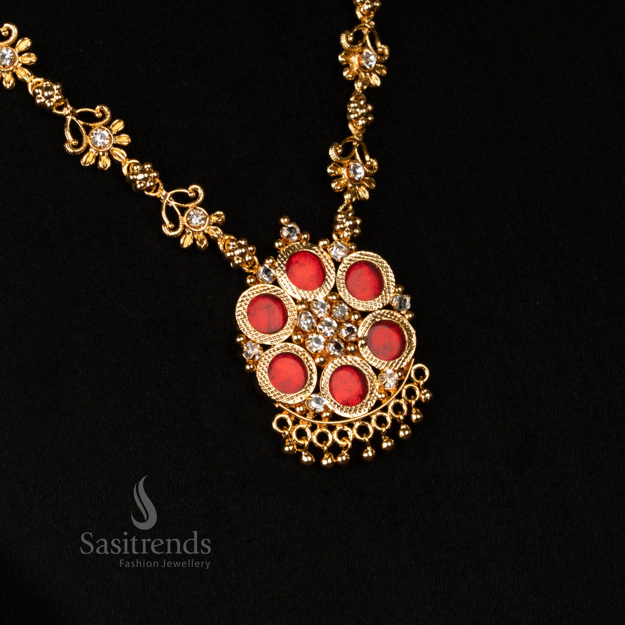 Grandiose micro gold plated Kerala Palakka necklace in ruby red, showcasing a finely adorned floral and round pendant, radiating traditional festive jewellery charm - Sasitrends