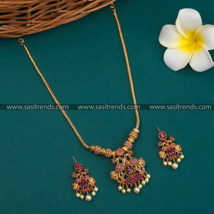 Micro Gold Plated Peacock Pendant Necklace Set with Earrings adorned with American Diamond Stones in Ruby hues - Perfect for Traditional Occasions