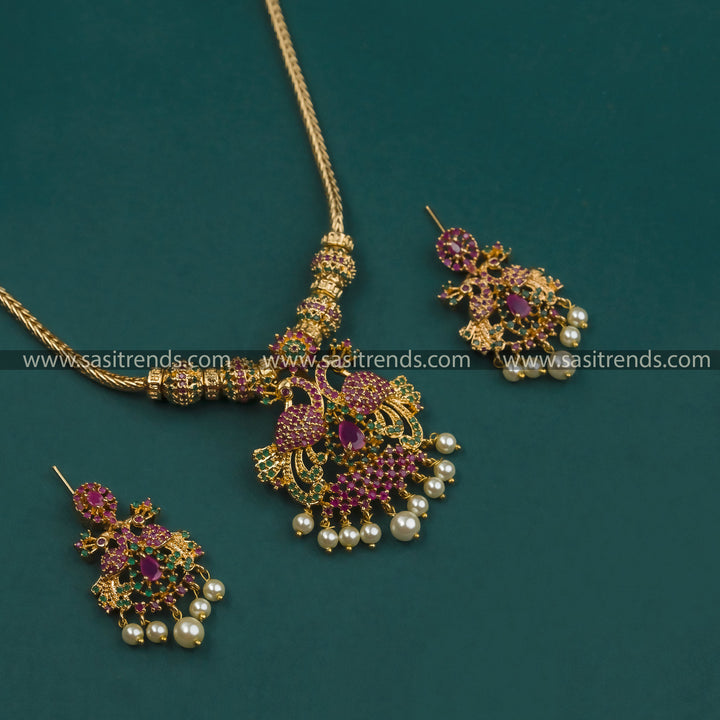 Gorgeous Micro Gold Plated Peacock Pendant Necklace Set with Earrings featuring American Diamond Stones in Ruby-Green shades 