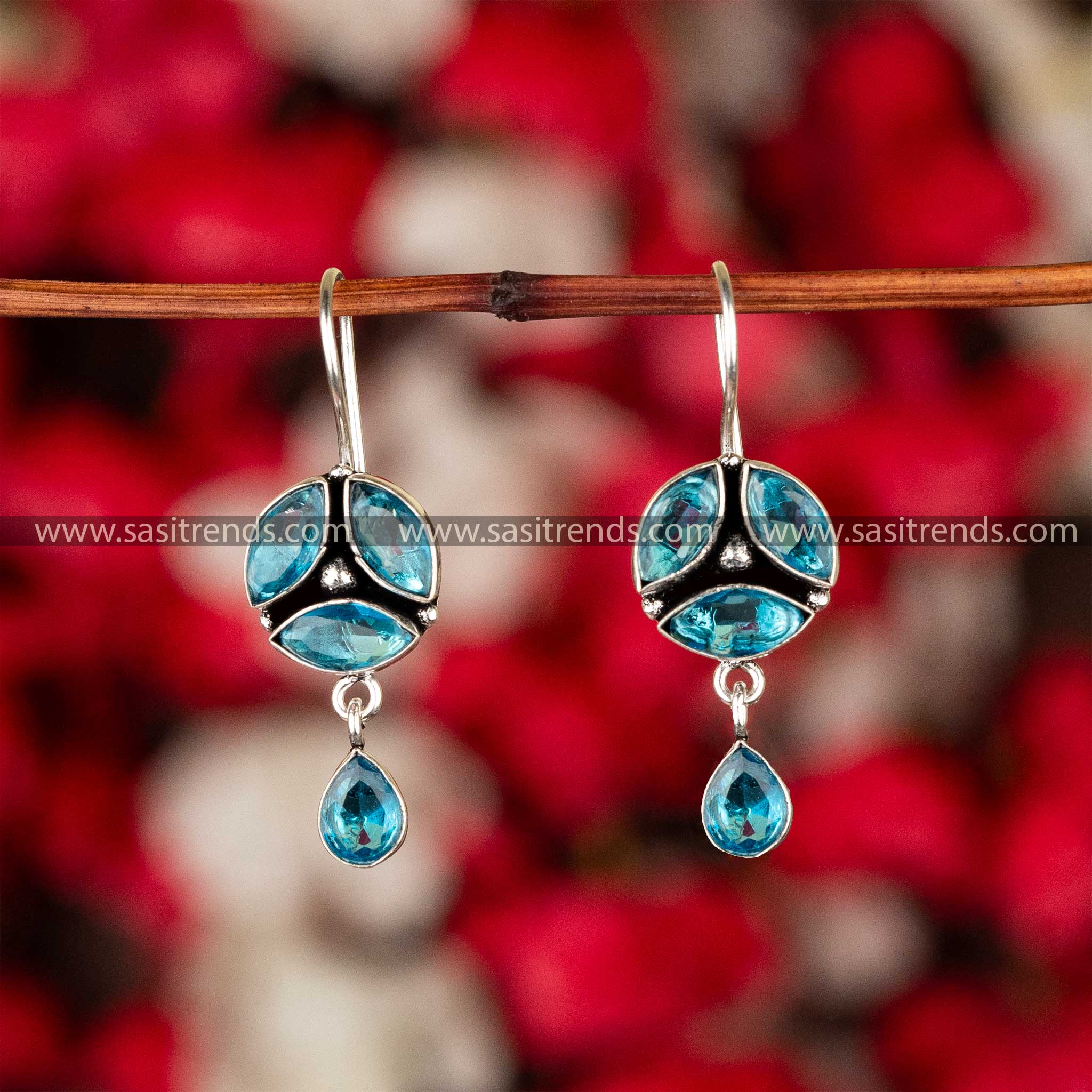 Aquamarine blue stone earrings with a reflective sheen on oxidised German silver