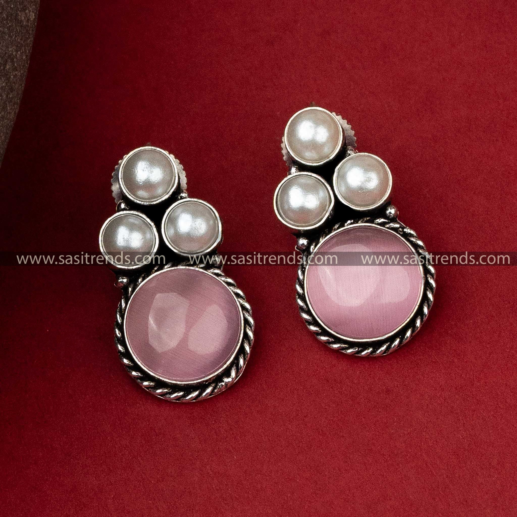 Sophisticated oxidised silver earrings with a delicate pink monalisa stone complemented by a pearl arrangement