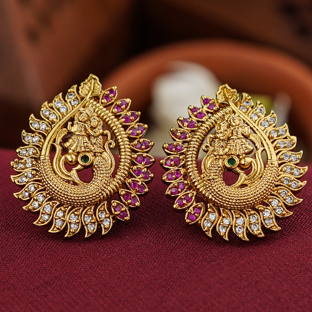 Radha and Krishna dancing on a peacock stud earring, symbolizing eternal love