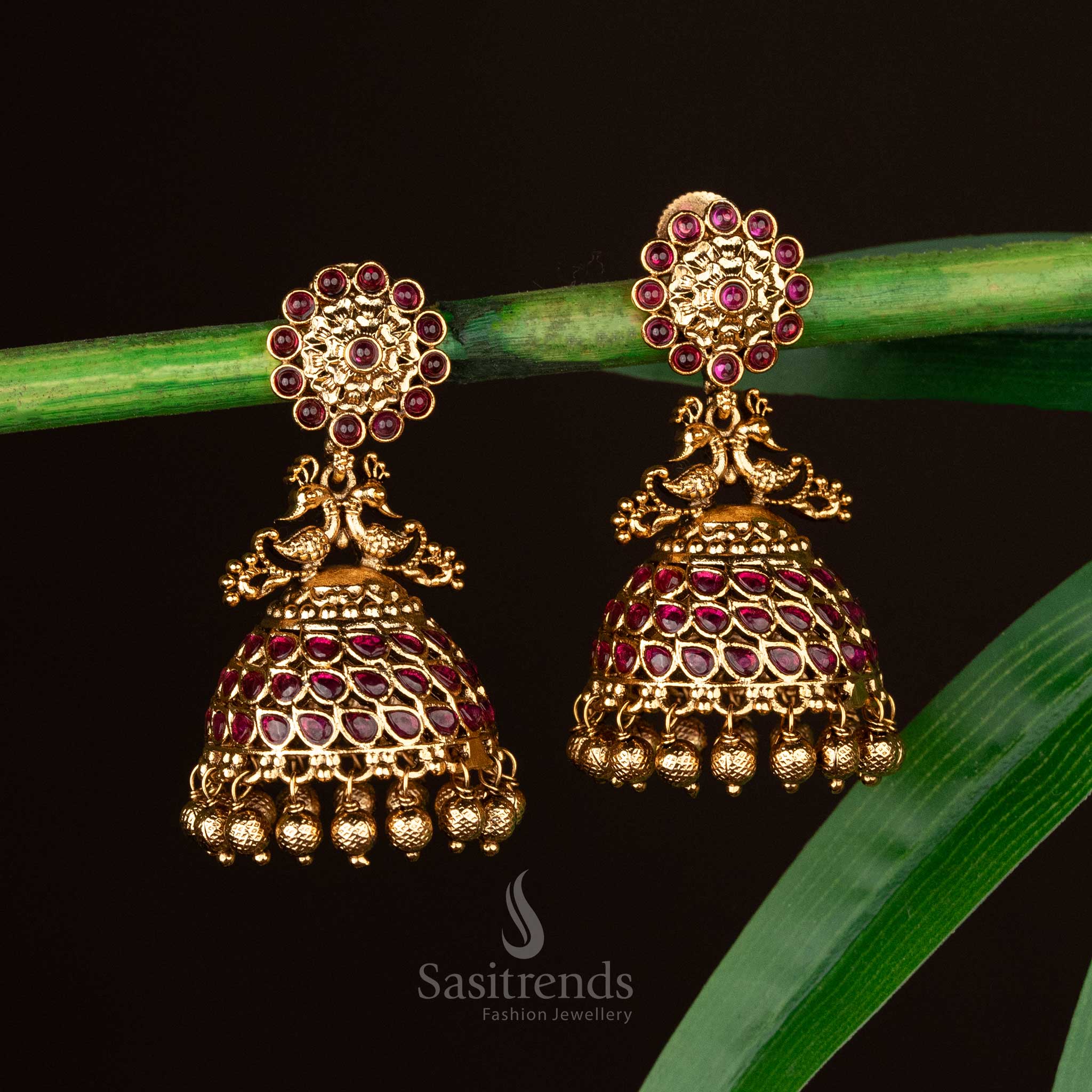 Ruby red stone temple jhumkas in matte gold with peacock motif - Sasitrends