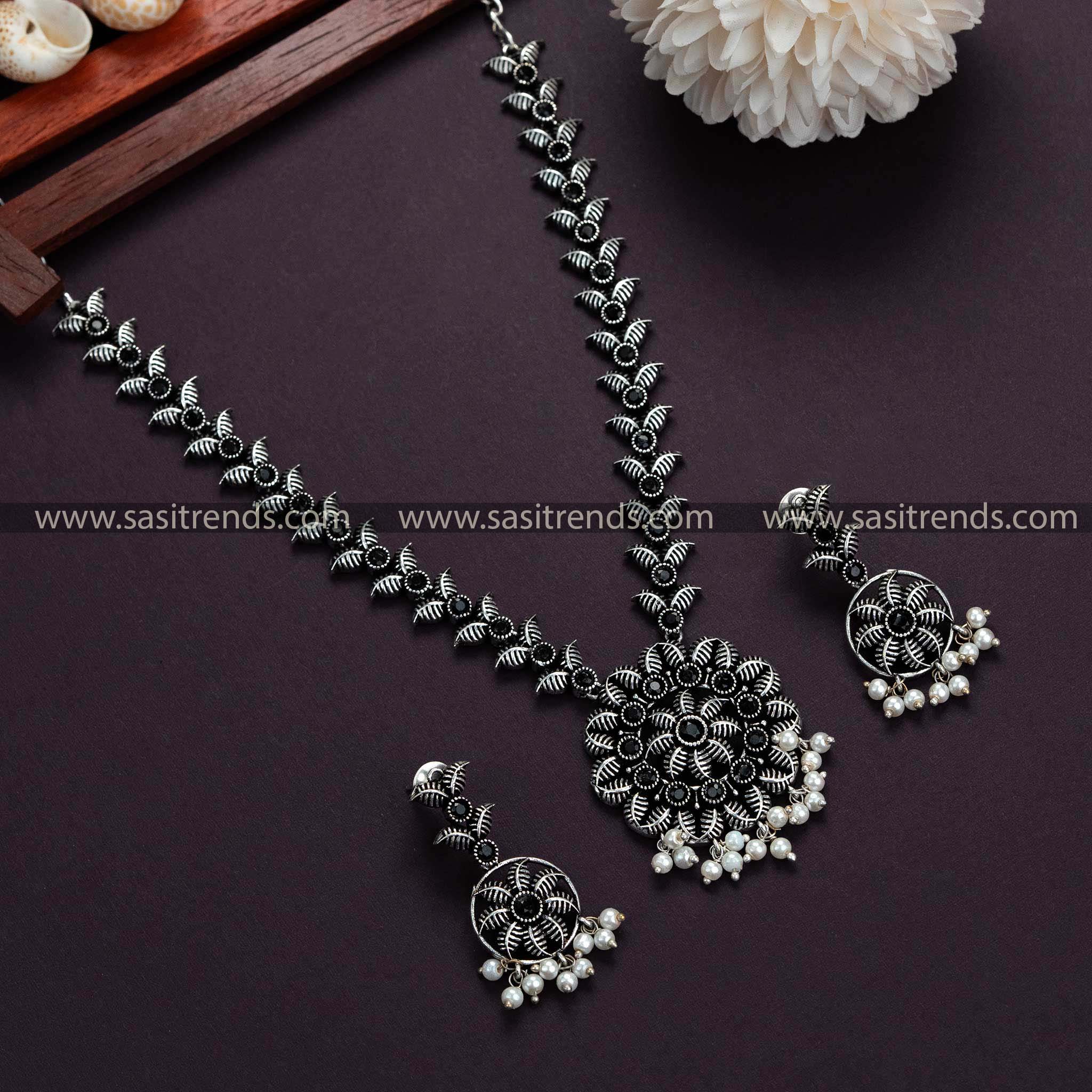 Dazzle in black stones on this Oxidised German Silver necklace with pearl earrings