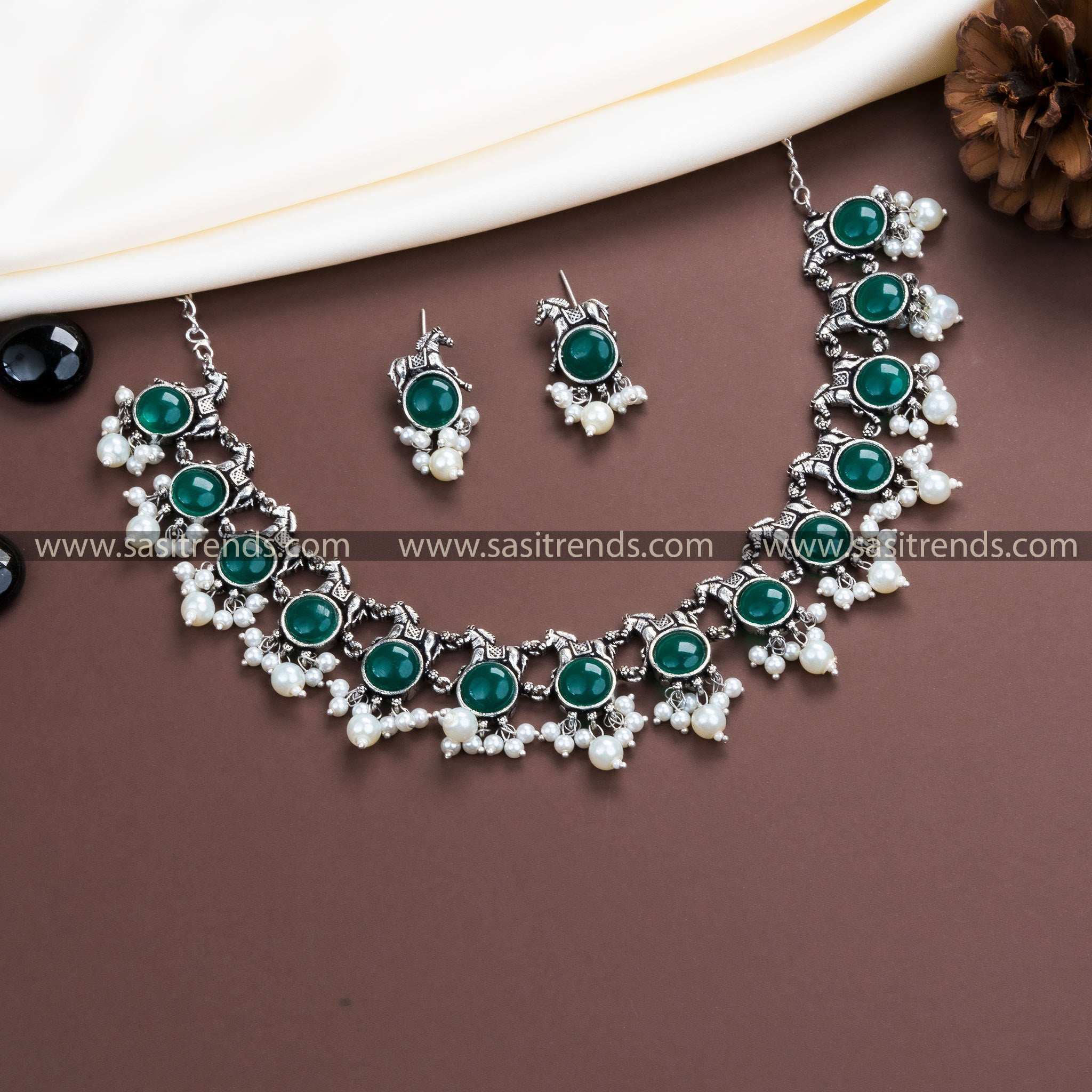 Vibrant Green Stone Embellishments on Trendy Party Wear Oxidised German Silver Horse Necklace with Pearl Earrings.