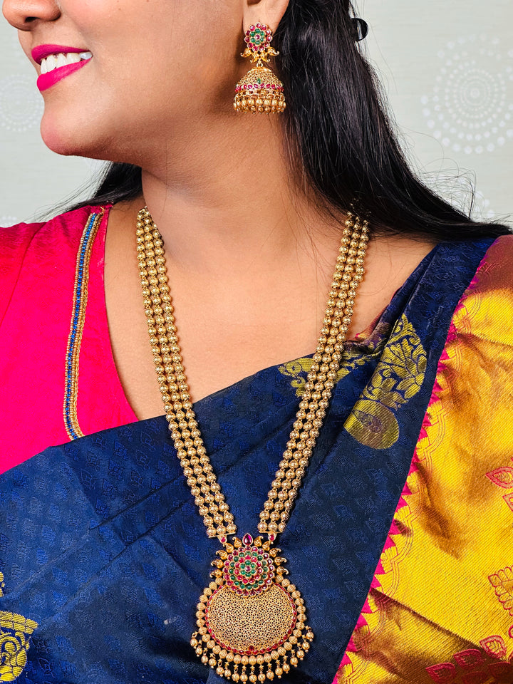 Matte Gold Traditional Long Necklace Set with Floral Pendant and Jhumkas