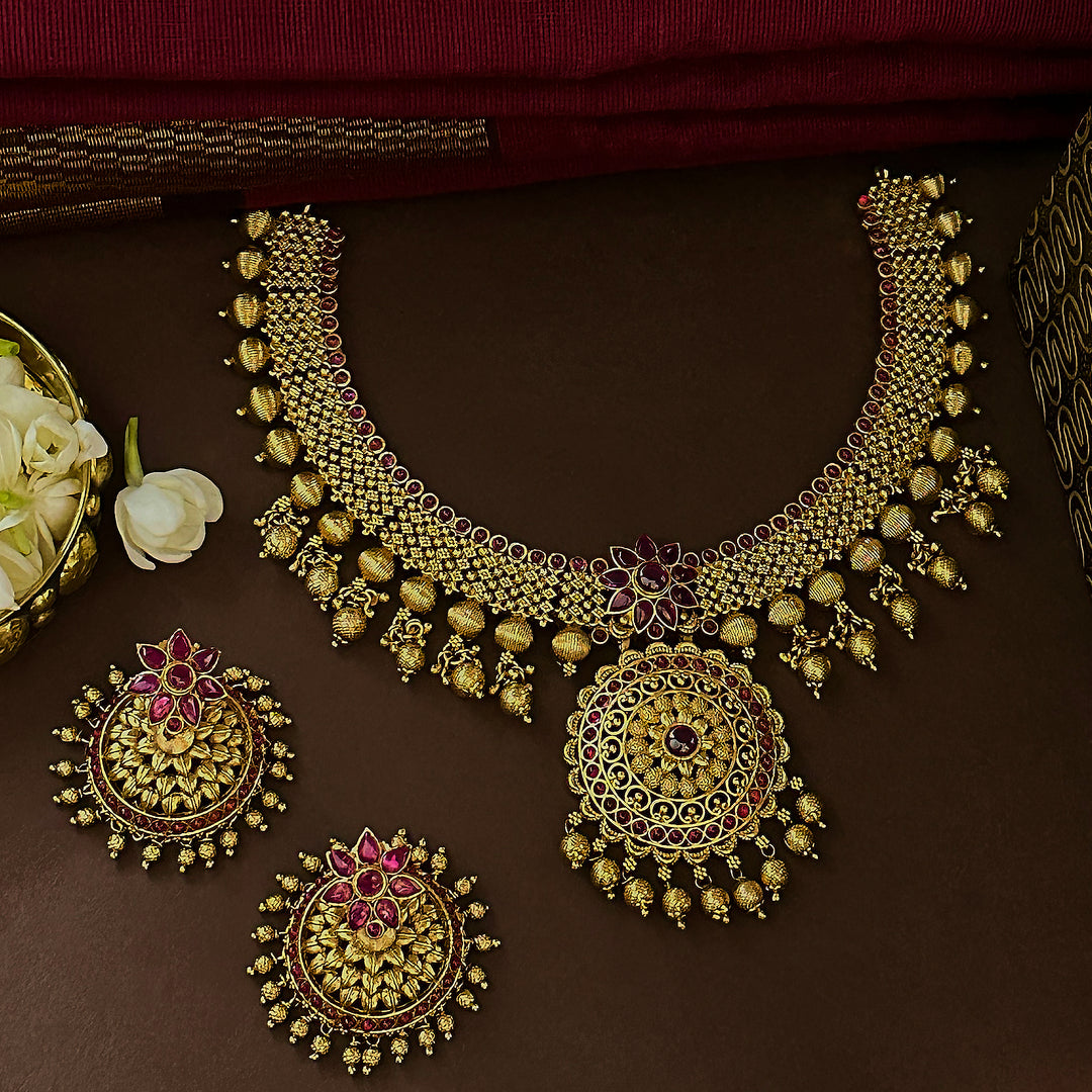 Traditional grand bridal floral necklace with matte gold plating and AD  Ruby stones for women.