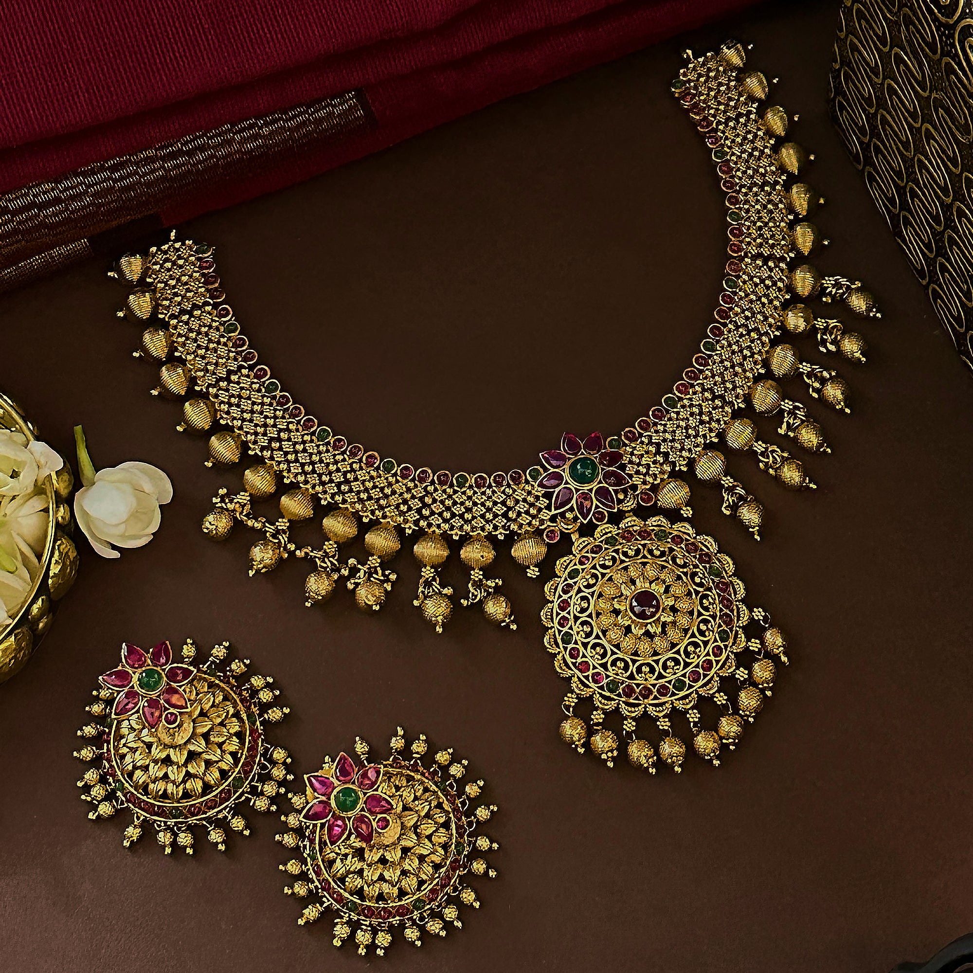 Traditional grand bridal floral necklace with matte gold plating and AD  Ruby-Green stones for women.