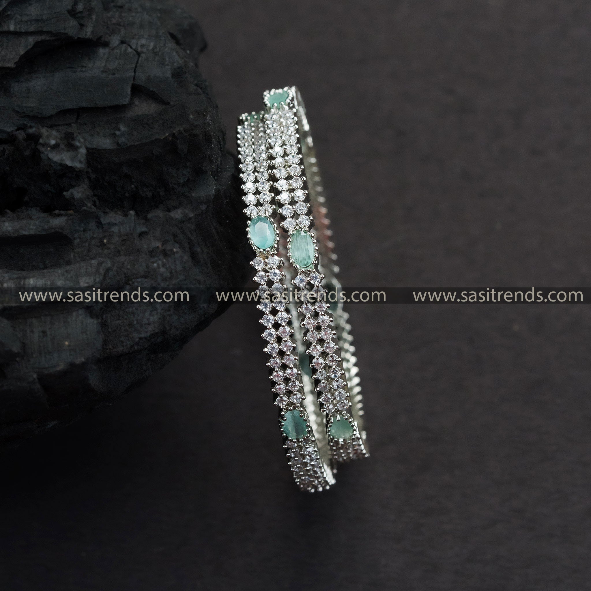 Stylish rhodium silver plated bangles with mint green American diamond stones, perfect for parties and festivals.