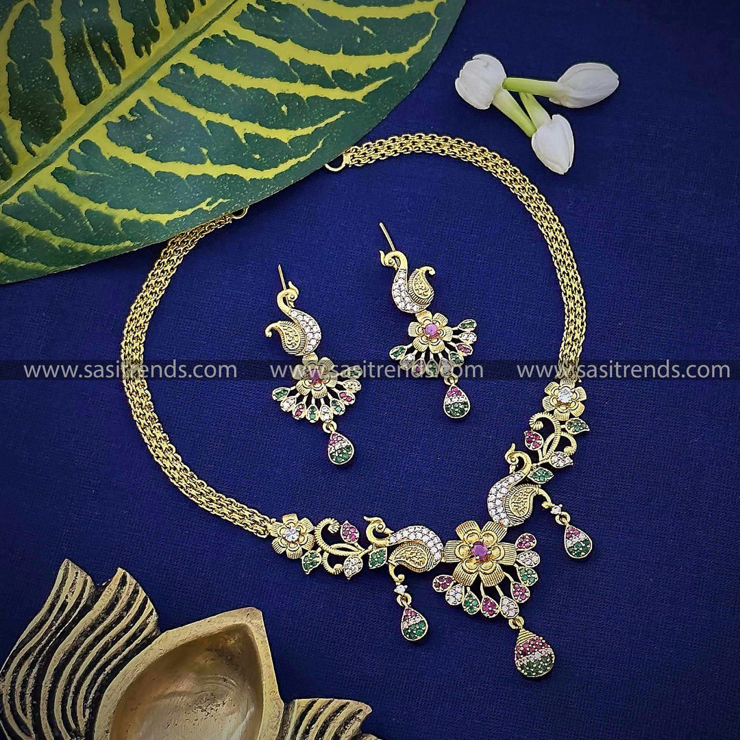 Traditional matte gold tone floral and peacock choker necklace with premium quality stones and earrings for women.