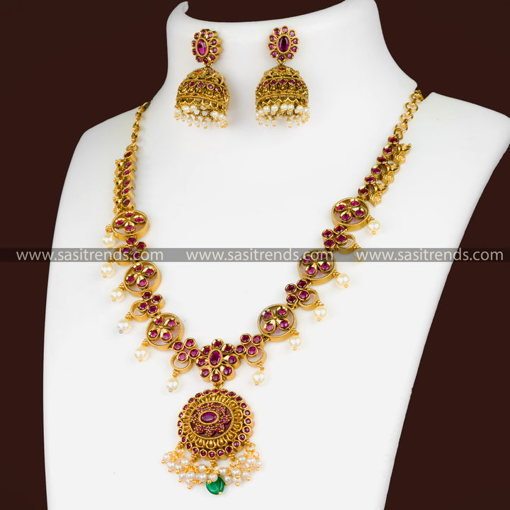 Matte Gold Necklace Set with Ruby Red Stones - Floral Pendant, Jhumkas, AD Stones, Hanging Pearls - Festival Jewelry