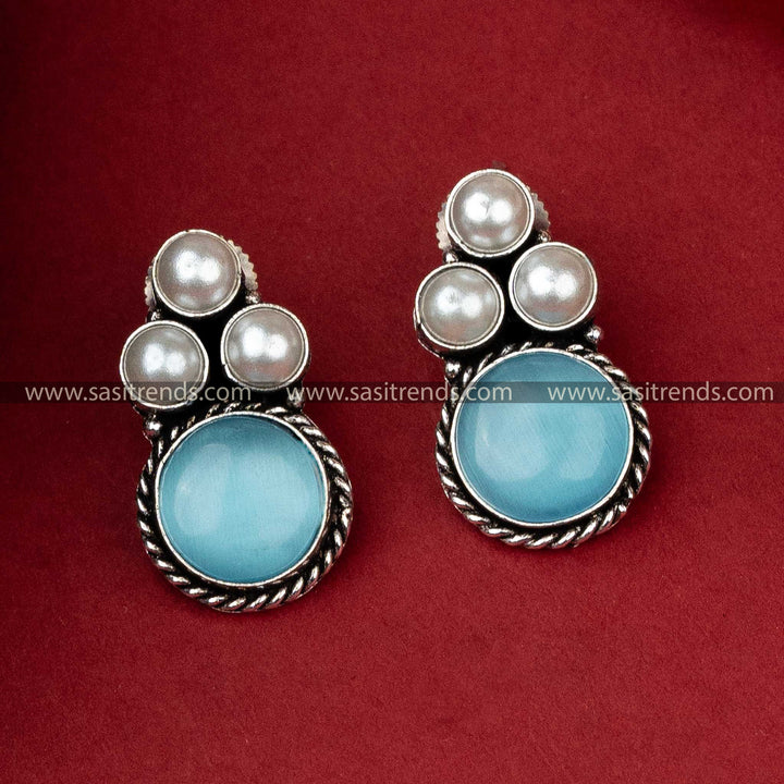 Unique oxidized silver earrings with a serene blue monalisa stone set beneath a cluster of gleaming pearls