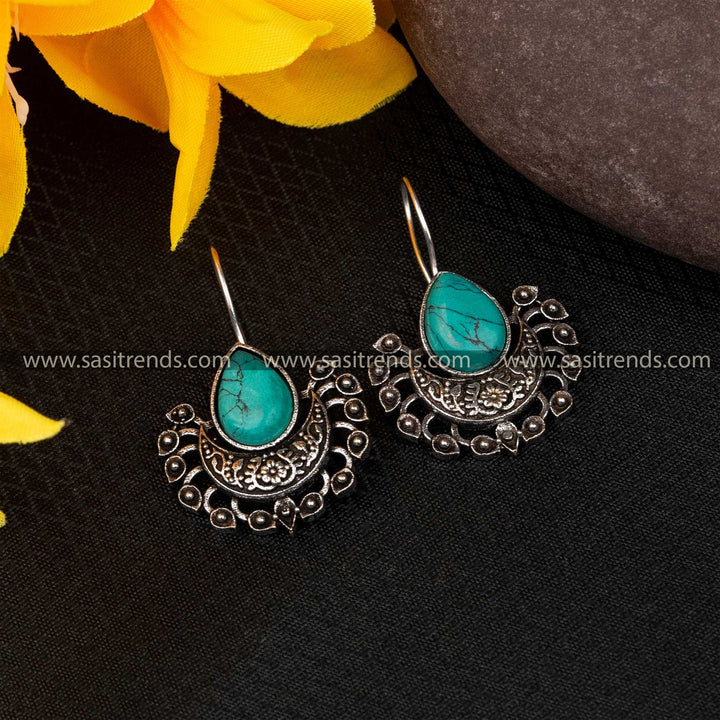 Turquoise blue stone fish hook earrings with intricate silver design