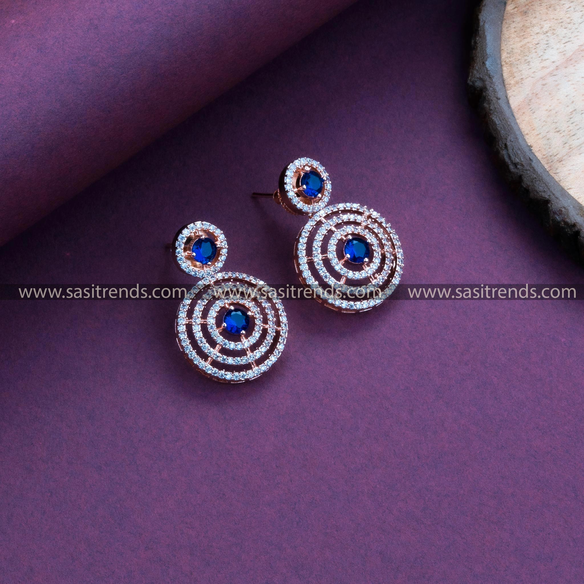 Stylish Party Wear Rose Gold Plated Earrings adorned with Blue Stones, Circle Pattern, and American Diamonds