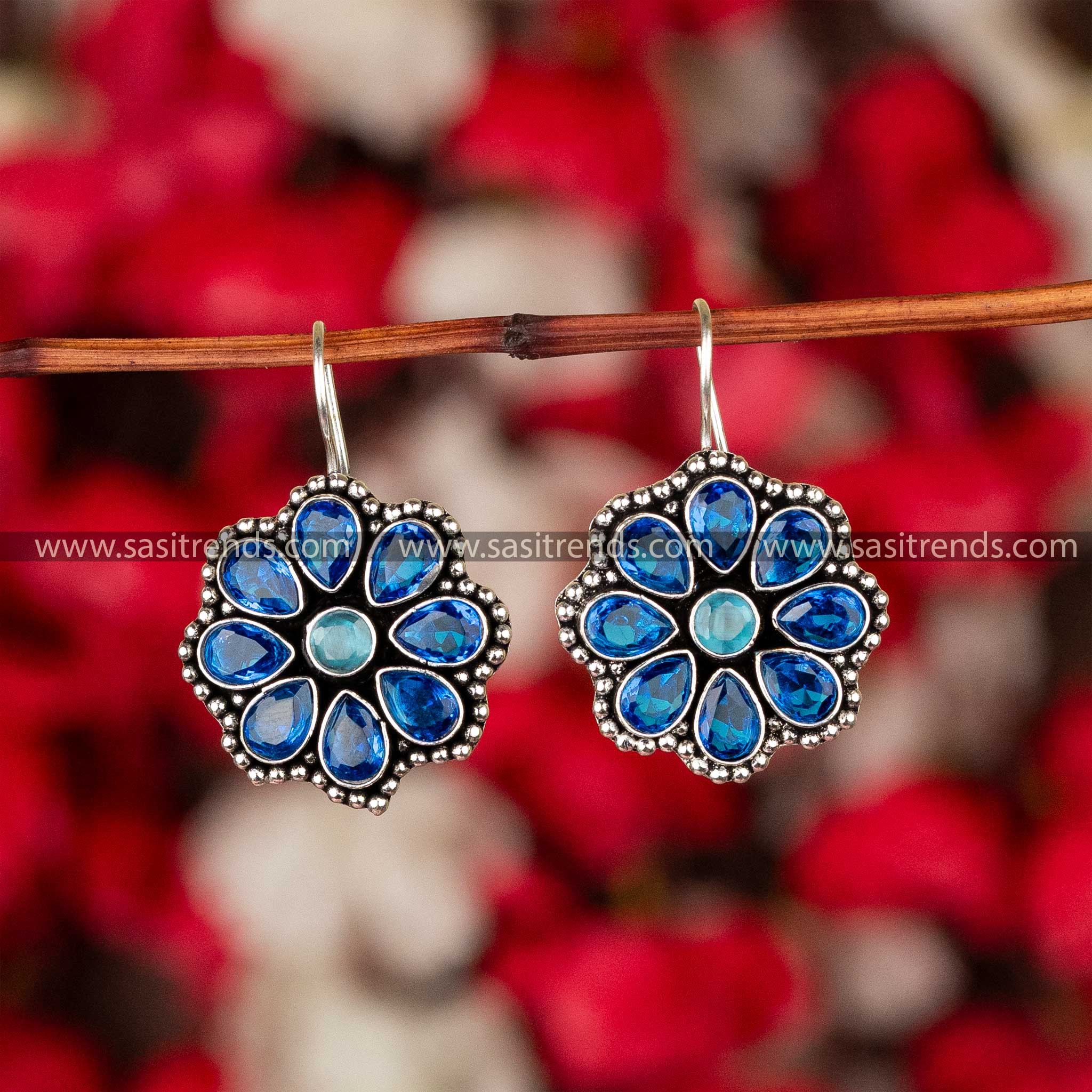 Ocean blue glittering stones set in oxidized silver floral earrings