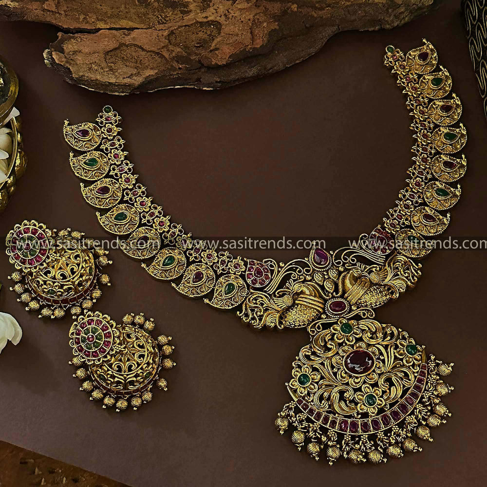 Traditional Bridal Wear Temple Gold Plated Peacock Mango Leaf Ruby-Green Necklace Set with Jhumkas