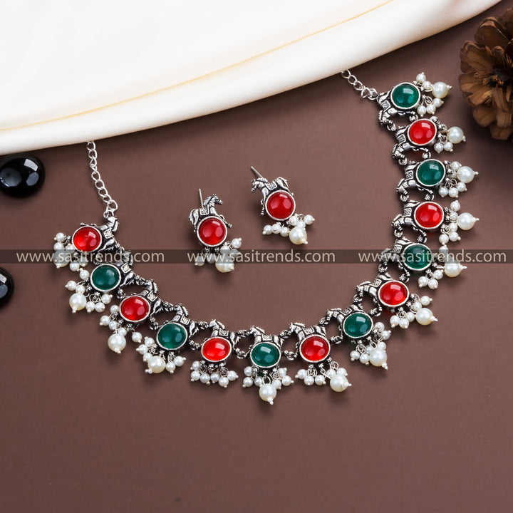 Dual-Toned Elegance: Oxidised German Silver Necklace with Pearl Horse Earrings and Striking Ruby-Green Stones.