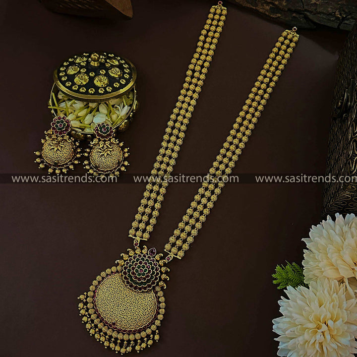 Grand Bridal Traditional Wear: Temple Matte Gold Tone Long Jewellery Set with Three-Layered Bead Floral Pendant and Jhumkas for Women