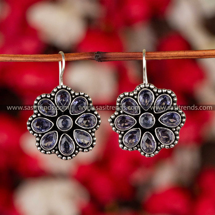 Dark sapphire blue stone-studded oxidized silver floral earrings