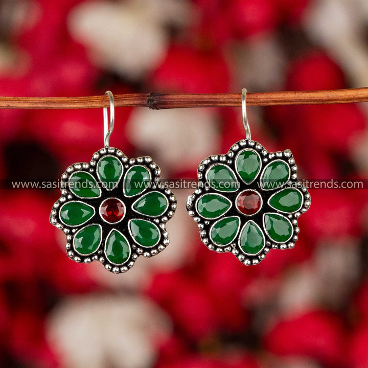 Emerald green stone-studded oxidized silver floral earrings