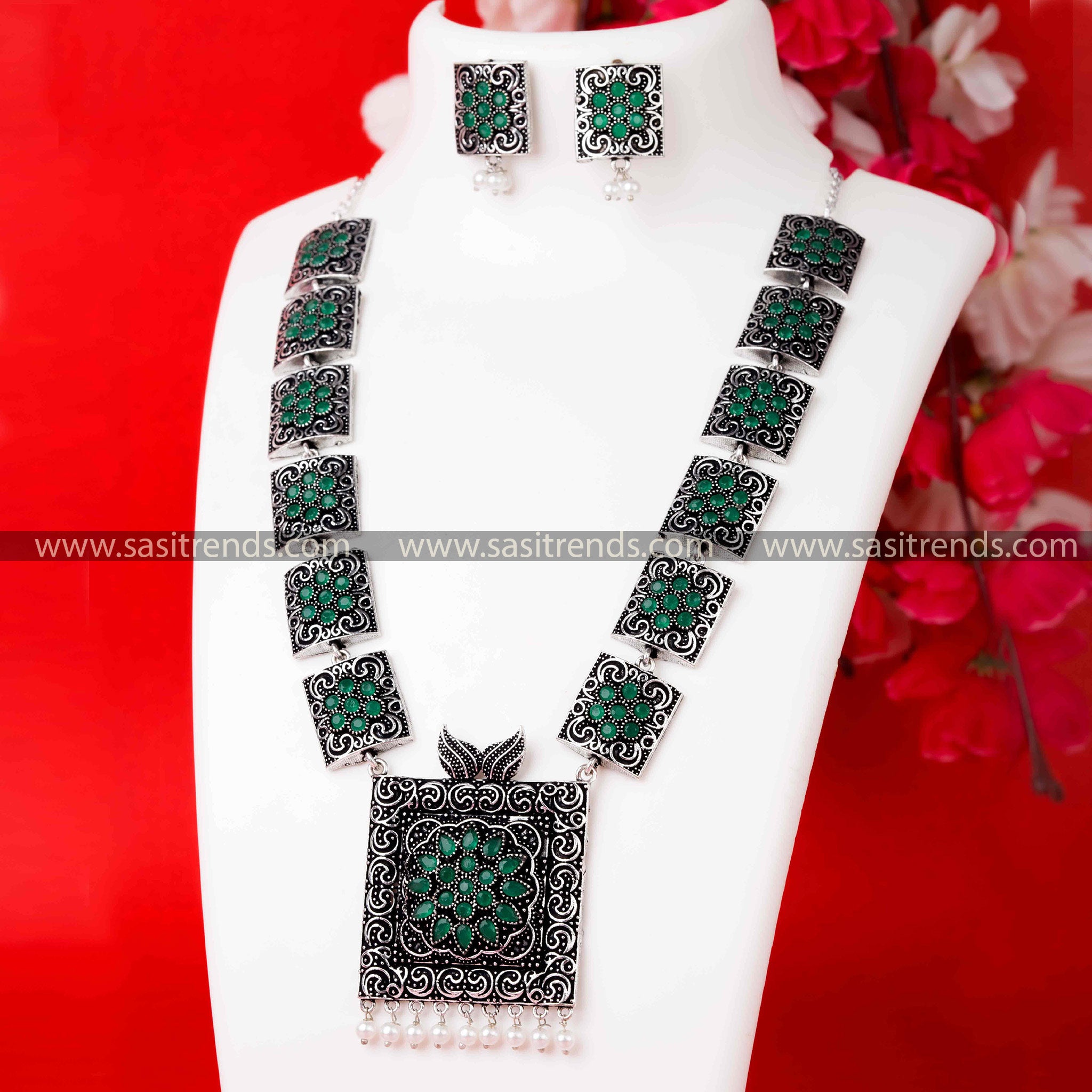 Oxidised German Silver Necklace with Captivating Green Stones Pendant and Harmonizing Pearl Earrings.