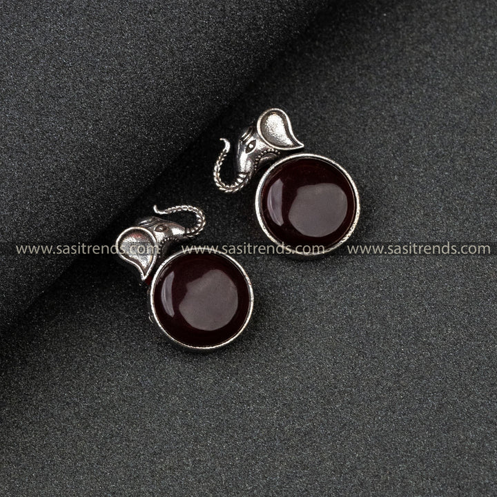 Traditional Wear Oxidised German Silver Elephant Head And Round Monalisa Stone Vinous Earrings