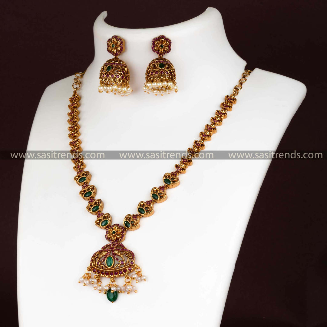 Matte gold floral pendant necklace set with AD stones and pearl jhumkas for women.