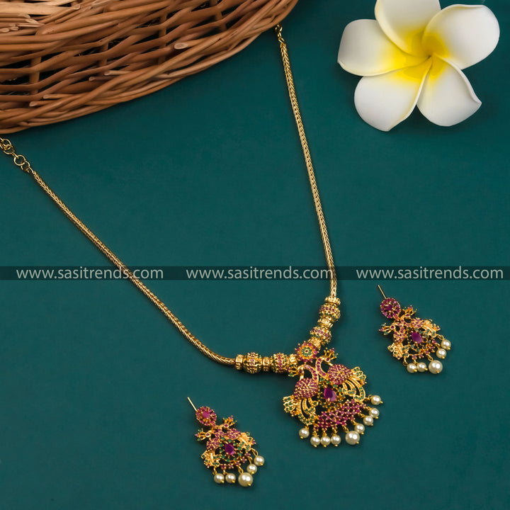 Elegant Micro Gold Plated Peacock Pendant Necklace Set with Earrings embellished with American Diamond Stones in Ruby-Green