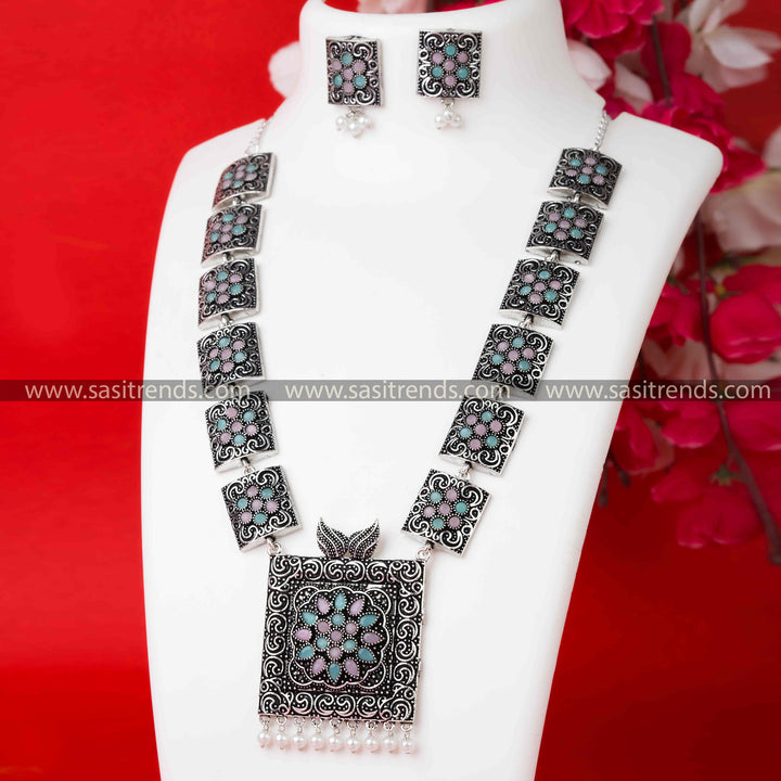 Trendy Party Wear Oxidised German Silver Pearl Necklace with Unique Mint-Pink Stone Pendant and Pearl Earrings.