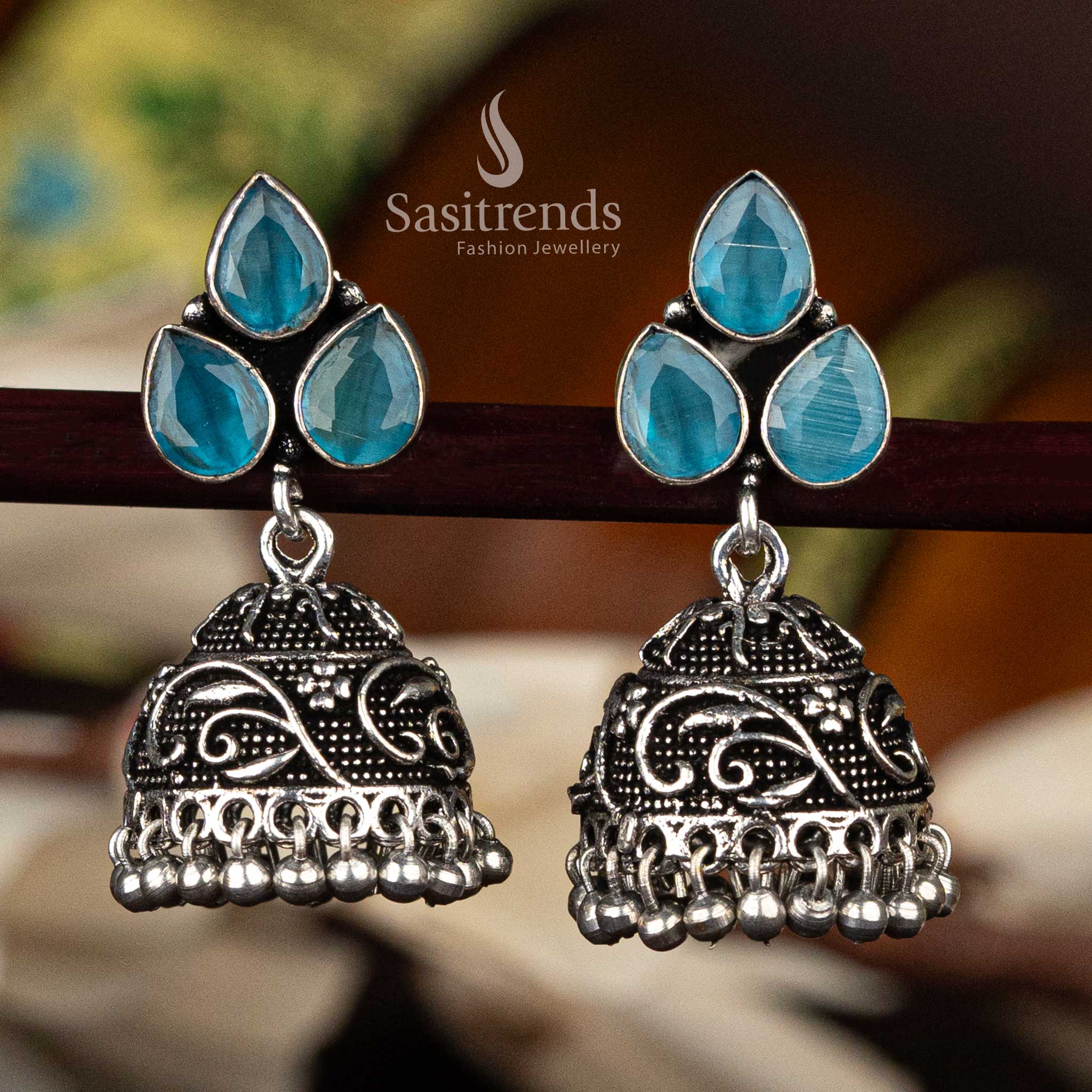 Traditional sky blue stone oxidised jhumka with floral leaf pattern and decorative bead fringe - Sasitrends