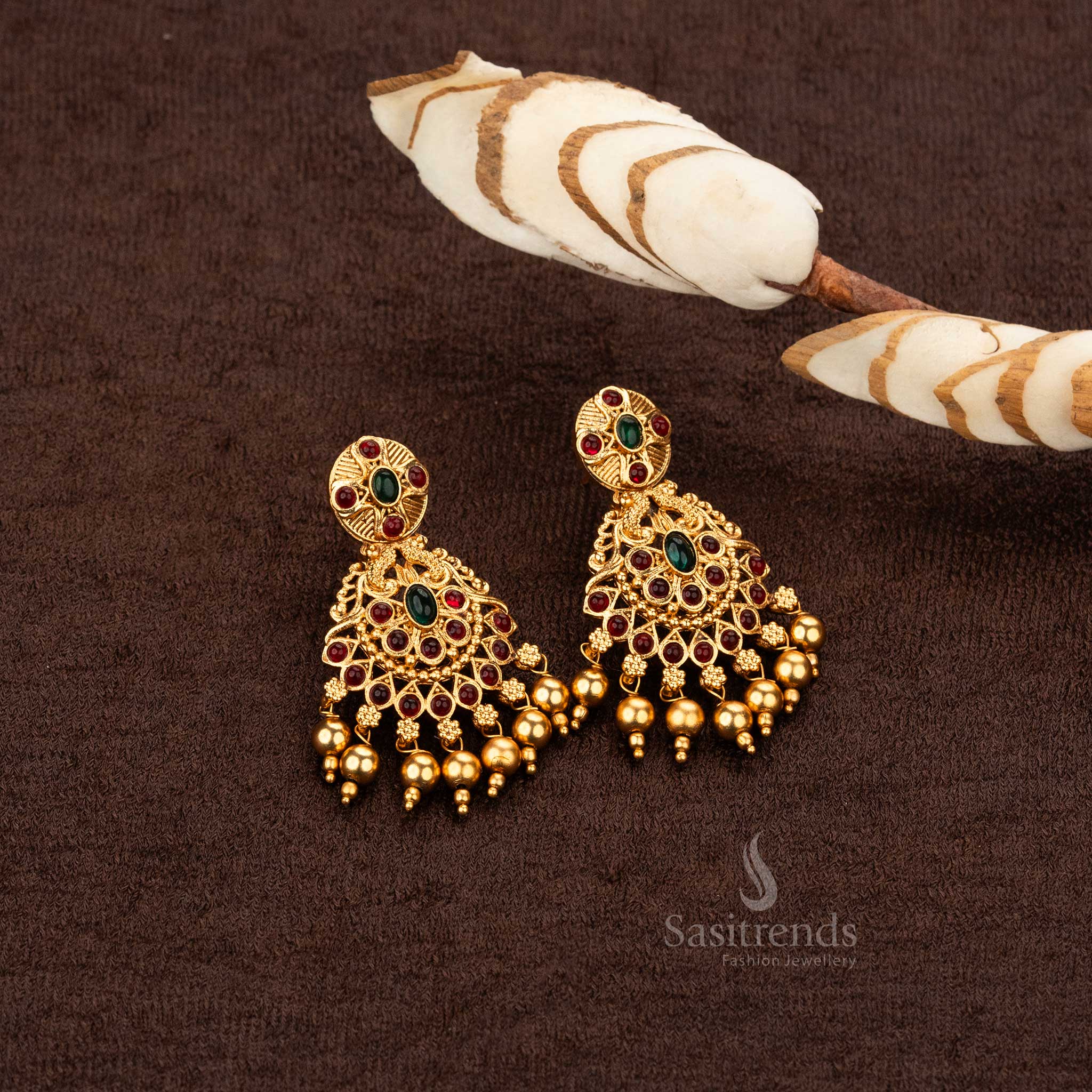 Designer earrings with ruby and green stones in a classic matte gold finish- Sasitrends