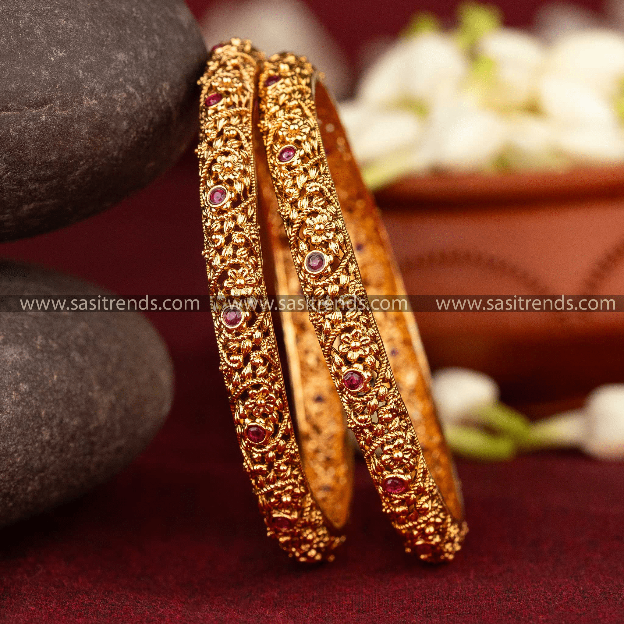 Front view of gold-plated bangles with flower design and Ruby & Green AD stones