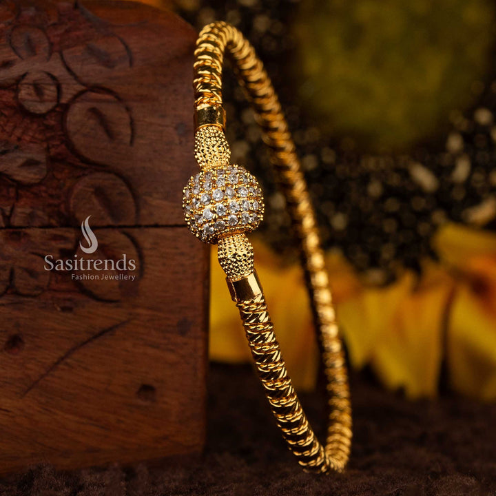 Micro gold plated 1 gram guaranteed twisted kada bangle with AD stone-studded ball in white color by Sasitrends